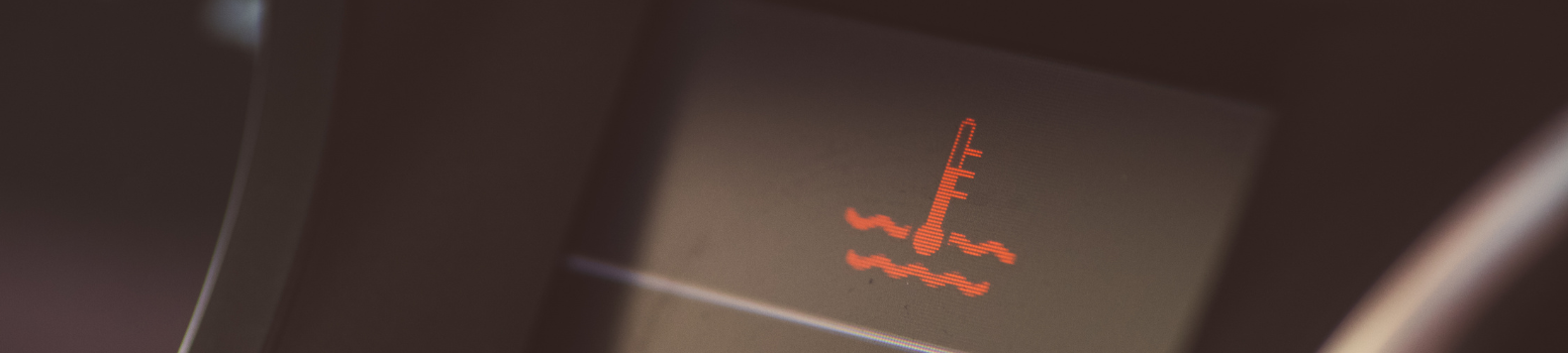 Rood dashboard lampje van een thermometer in vloeistof: De motor is oververhit