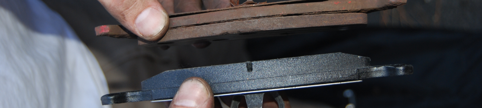 Een oud, roestig remblok (boven) tegenover een nieuw remblok (onder). Het frictiemateriaal van het oude remblok is ongeveer een halve cm dik, dat van het nieuwe bijne 1 cm. In het midden van het nieuwe remblok zie je de gleuf van de akoestische slijtagewaarschuwing.